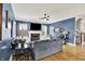 Comfortable living room with hardwood floors, a fireplace, and large windows for ample natural light at 12999 Deerstyne Green St, Carmel, IN 46032