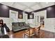Inviting living room featuring a comfortable sofa, classic piano, and abundant natural light from large windows at 12999 Deerstyne Green St, Carmel, IN 46032