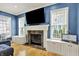 Comfortable living room boasts a stone fireplace, custom built-ins and large windows with tons of natural light at 12999 Deerstyne Green St, Carmel, IN 46032