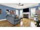 Cozy living room with hardwood floors, a stone fireplace, and comfortable sofa perfect for relaxing at 12999 Deerstyne Green St, Carmel, IN 46032