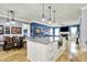 Spacious open living area with kitchen island, dining table and comfortable seating by a fireplace at 12999 Deerstyne Green St, Carmel, IN 46032