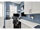 Well lit modern home office featuring built-in desk with storage, comfortable seating, and two monitors for efficiency at 12999 Deerstyne Green St, Carmel, IN 46032