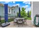 A patio featuring a dining table with umbrella, surrounded by lush greenery at 12999 Deerstyne Green St, Carmel, IN 46032
