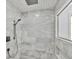 Luxurious walk-in shower with marble tiling, mosaic accents, and a modern shower head at 12999 Deerstyne Green St, Carmel, IN 46032