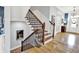Elegant staircase with hardwood steps, wrought iron railings, and white risers, leading to the upper level at 12999 Deerstyne Green St, Carmel, IN 46032