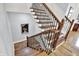 An elegant staircase showcases hardwood steps, a decorative railing, and a clear view down to the first floor at 12999 Deerstyne Green St, Carmel, IN 46032