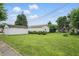 Spacious backyard featuring a detached garage and lush green lawn under a blue sky at 1331 S 9Th St, Noblesville, IN 46060