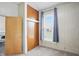 Cozy bedroom featuring wood paneling, closet, window with blind, and neutral carpet at 1331 S 9Th St, Noblesville, IN 46060