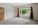 Bright bedroom featuring a neutral color palette, a large window, and carpeted flooring at 1331 S 9Th St, Noblesville, IN 46060