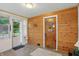 Inviting entryway with a wooden accent wall, front door, and light-filled window at 1331 S 9Th St, Noblesville, IN 46060