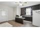 This cozy kitchen features dark cabinetry, a peninsula counter, and modern appliances at 1331 S 9Th St, Noblesville, IN 46060
