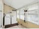 Functional laundry room with washer, dryer, storage shelves, and abundant natural light at 1331 S 9Th St, Noblesville, IN 46060