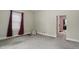 Bright living room with neutral walls, carpeted floors, and large window with curtains at 1331 S 9Th St, Noblesville, IN 46060