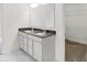 Bathroom featuring double vanity with grey countertops and white cabinets, marble floors, and walk-in closet at 1354 Sambar Ct, Greenwood, IN 46143