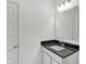 Clean half-bathroom with a dark countertop, mirror, and modern fixtures at 1354 Sambar Ct, Greenwood, IN 46143