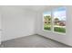 Bright bedroom featuring plush carpet, white trim, and two large windows offering plenty of natural light at 1354 Sambar Ct, Greenwood, IN 46143