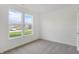 Bright bedroom with plush carpeting and double windows showcasing the neighborhood at 1354 Sambar Ct, Greenwood, IN 46143