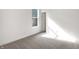 Sun-filled bedroom boasts neutral carpet, white walls and door, with natural light streaming through the window at 1354 Sambar Ct, Greenwood, IN 46143