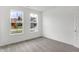 Bright bedroom featuring neutral carpet, fresh white walls, and views from two well-sized windows at 1354 Sambar Ct, Greenwood, IN 46143