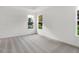 A carpeted bedroom with natural lighting and views from the large windows at 1354 Sambar Ct, Greenwood, IN 46143