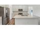 Well-equipped kitchen with stainless steel appliances, a center island, and gray cabinetry, perfect for culinary enthusiasts at 1354 Sambar Ct, Greenwood, IN 46143