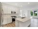 Bright kitchen featuring white cabinets, stainless steel appliances, quartz countertops, and a center island with a sink at 1354 Sambar Ct, Greenwood, IN 46143