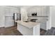Modern kitchen featuring gray cabinets, stainless steel appliances, quartz countertops, and a spacious center island at 1354 Sambar Ct, Greenwood, IN 46143