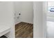 Compact laundry room with washer and dryer connections, featuring wood flooring and bright, white walls at 1354 Sambar Ct, Greenwood, IN 46143