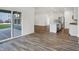 Bright open-plan living space with wood floors and access to an outdoor area and a kitchen with stainless steel appliances at 1354 Sambar Ct, Greenwood, IN 46143