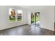 Bright room with windows and a sliding door that leads to an outdoor patio, featuring wood floors and neutral decor at 1354 Sambar Ct, Greenwood, IN 46143