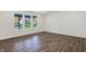 Neutral room with wood floors and large windows providing ample natural light and neighborhood views at 1354 Sambar Ct, Greenwood, IN 46143