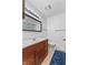 A clean bathroom features a wood vanity, neutral countertop and a patterned shower curtain at 150 Dominion Dr, Zionsville, IN 46077