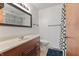 A clean bathroom features a wood vanity, neutral countertop and a patterned shower curtain at 150 Dominion Dr, Zionsville, IN 46077