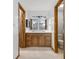 A bright bathroom features a double sink vanity with wood cabinets and updated fixtures and lighting at 150 Dominion Dr, Zionsville, IN 46077