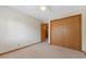 Comfortable bedroom featuring soft carpet, a closet for storage, and a door leading to the ensuite bathroom at 150 Dominion Dr, Zionsville, IN 46077