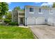 Charming townhouse with blue siding, stone accents, and attached two-car garage, perfect for comfortable living at 150 Dominion Dr, Zionsville, IN 46077