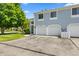 Townhouse with blue siding and a two-car garage, set in a well-maintained neighborhood with mature trees at 150 Dominion Dr, Zionsville, IN 46077