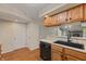 Efficient kitchen design with dark appliances, plenty of storage, and hardwood flooring in a naturally lit space at 150 Dominion Dr, Zionsville, IN 46077
