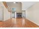 Spacious living room with hardwood flooring, a cozy fireplace, and abundant natural light from large windows at 150 Dominion Dr, Zionsville, IN 46077
