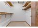 This walk-in closet features neutral carpet, shelving and rods to keep everything organized at 150 Dominion Dr, Zionsville, IN 46077