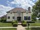 Elegant two-story home featuring a stone facade, brick walkway, manicured lawn and professionally landscaped front yard at 1809 Milford St, Carmel, IN 46032
