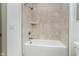 Bright bathroom featuring a tiled shower with a built-in shelf and updated fixtures at 1818 Central Ave, Indianapolis, IN 46202