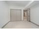 Bedroom with carpeting and trim, features a closet and an open door to another room at 1818 Central Ave, Indianapolis, IN 46202