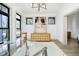 Living room with a glass table, modern chandelier, and an abstract painting above a console table at 1818 Central Ave, Indianapolis, IN 46202
