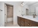 Bathroom featuring double sink vanity with marble countertop, bronze fixtures, and tiled shower at 1822 Central Ave, Indianapolis, IN 46202