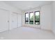 Bright, modern bedroom with large windows, plush carpeting, and closet with sliding doors at 1822 Central Ave, Indianapolis, IN 46202