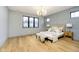 Bedroom with hardwood floors, a large window and stylish chandelier at 1822 Central Ave, Indianapolis, IN 46202