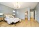 Bedroom featuring hardwood floors, a large window and walk-in closet at 1822 Central Ave, Indianapolis, IN 46202