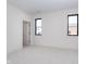 Spacious bedroom with neutral carpet, two windows, an open doorway, and neutral paint at 1822 Central Ave, Indianapolis, IN 46202