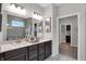 Elegant bathroom with double vanity, framed mirror, decor and a glass enclosed shower at 19348 Mcbee Ave, Westfield, IN 46074